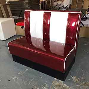 Glossy American style restaurant ruby and white 50's diner booth seating, midcentury glossy ruby color retro dining booth couches